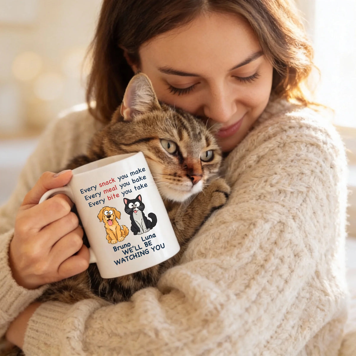 Tasse „Every Snack“ in der Hand einer Frau mit Katze